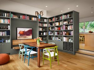 Colorful collection of wishbone chairs and gorgeous gray bookshelves add to the charm of this dining room 300x225 - MAKE YOUR DINING ROOM WORK FOR YOU