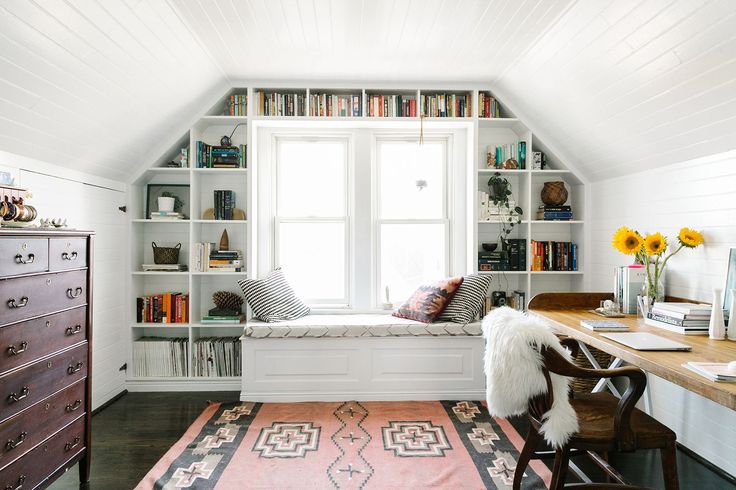Attic office space with great shelving around window - 6 potential home office spots that you might not have considered